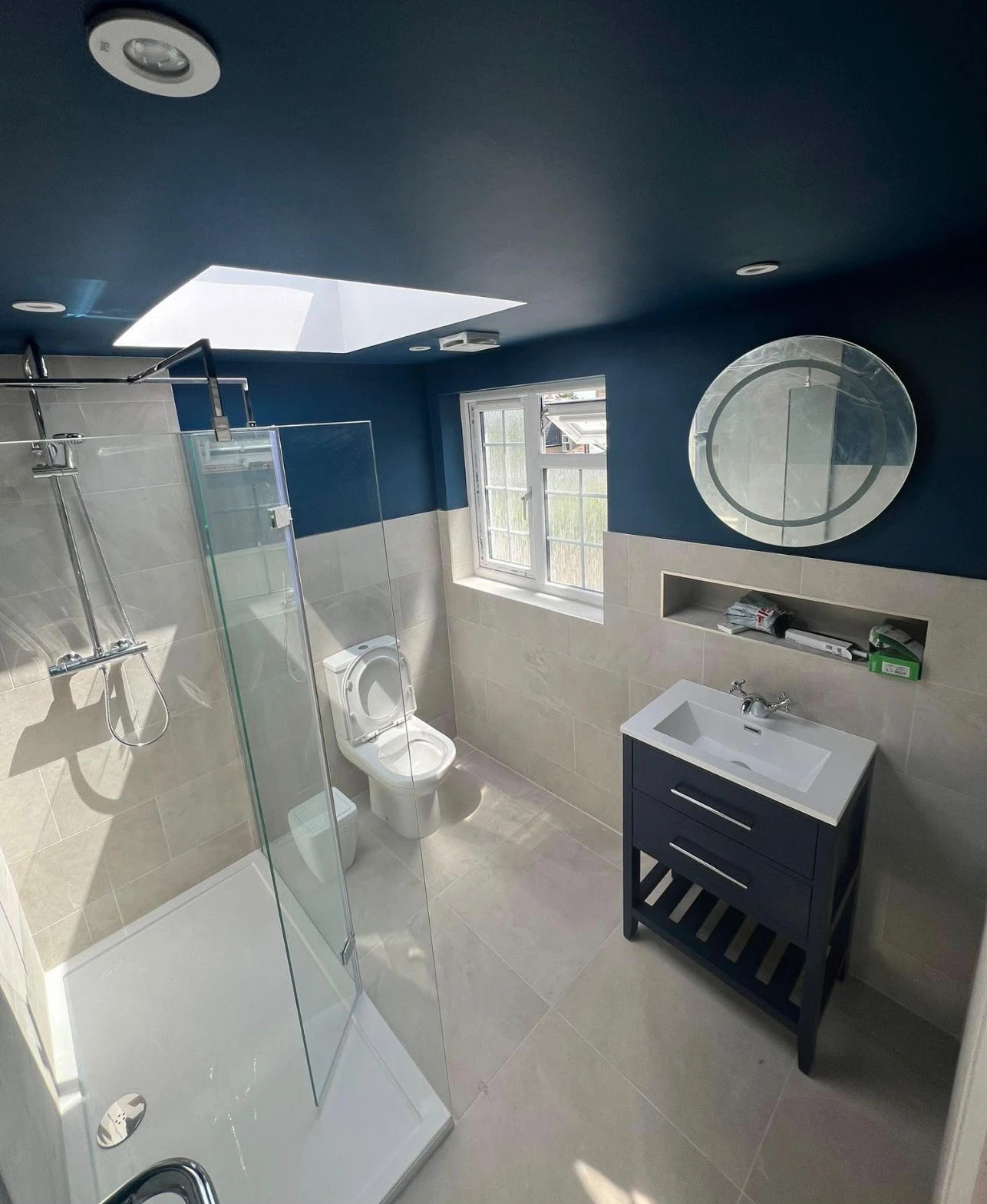 Bathroom interior painting with deep navy ceiling and walls above tiling