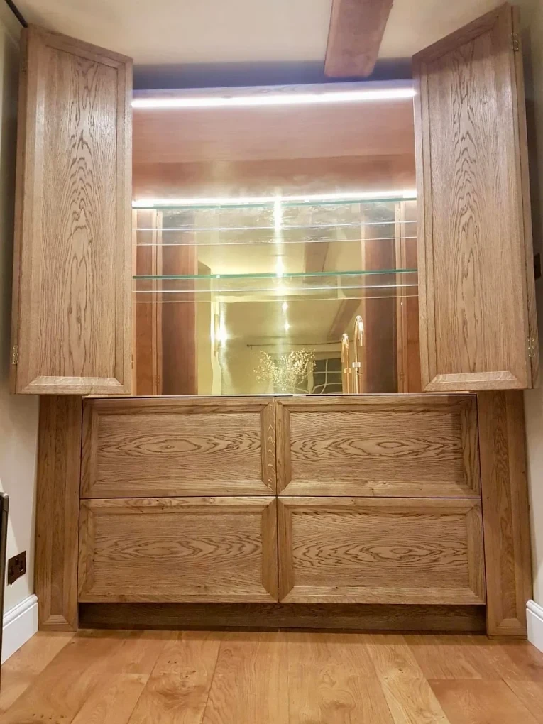 Treated oak drinks cabinet with lit glass shelves