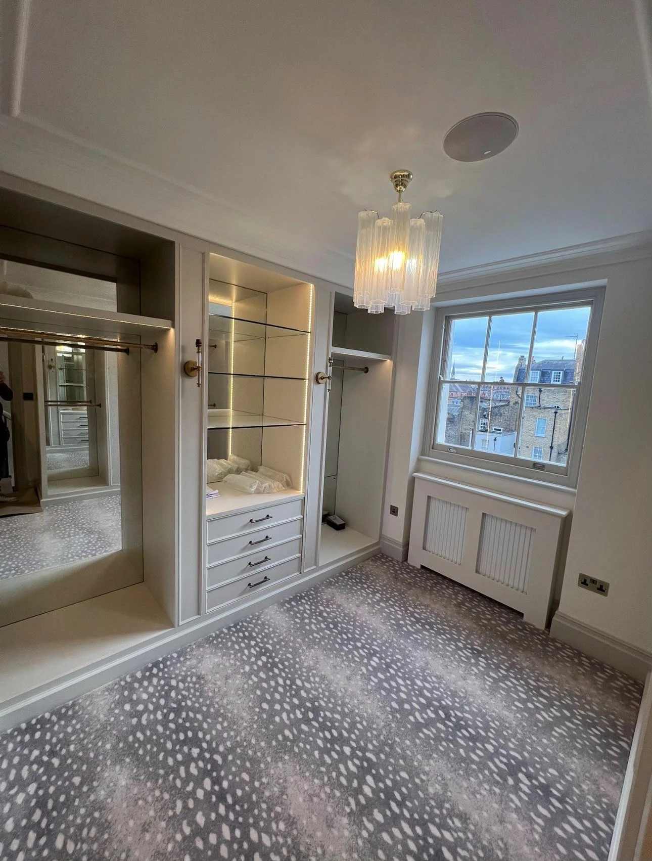 Painted built-in dressing room joinery with mirrored panels