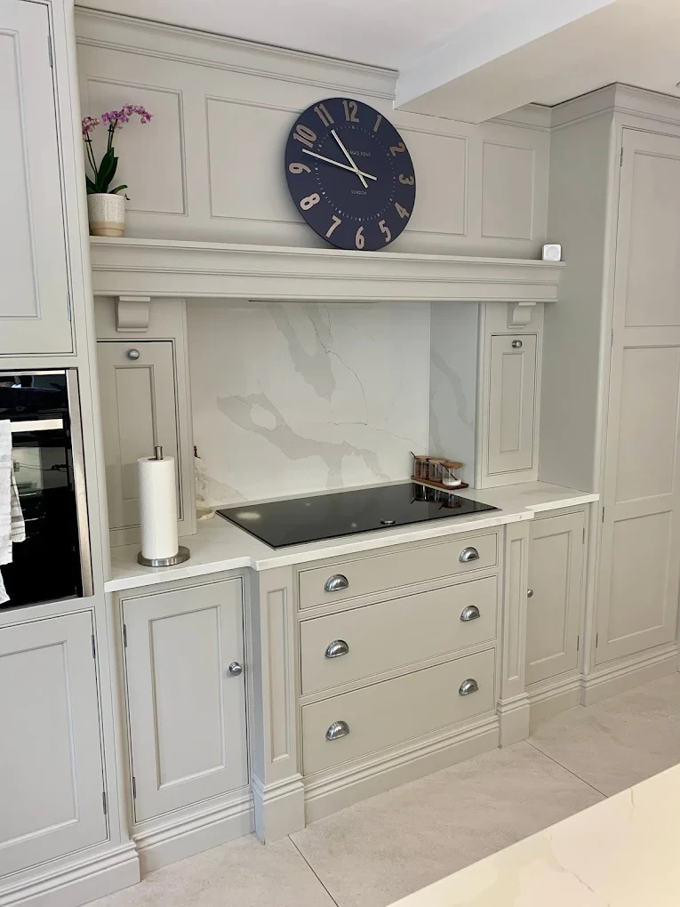 Painted kitchen run with mantle-style hood surround and drawers