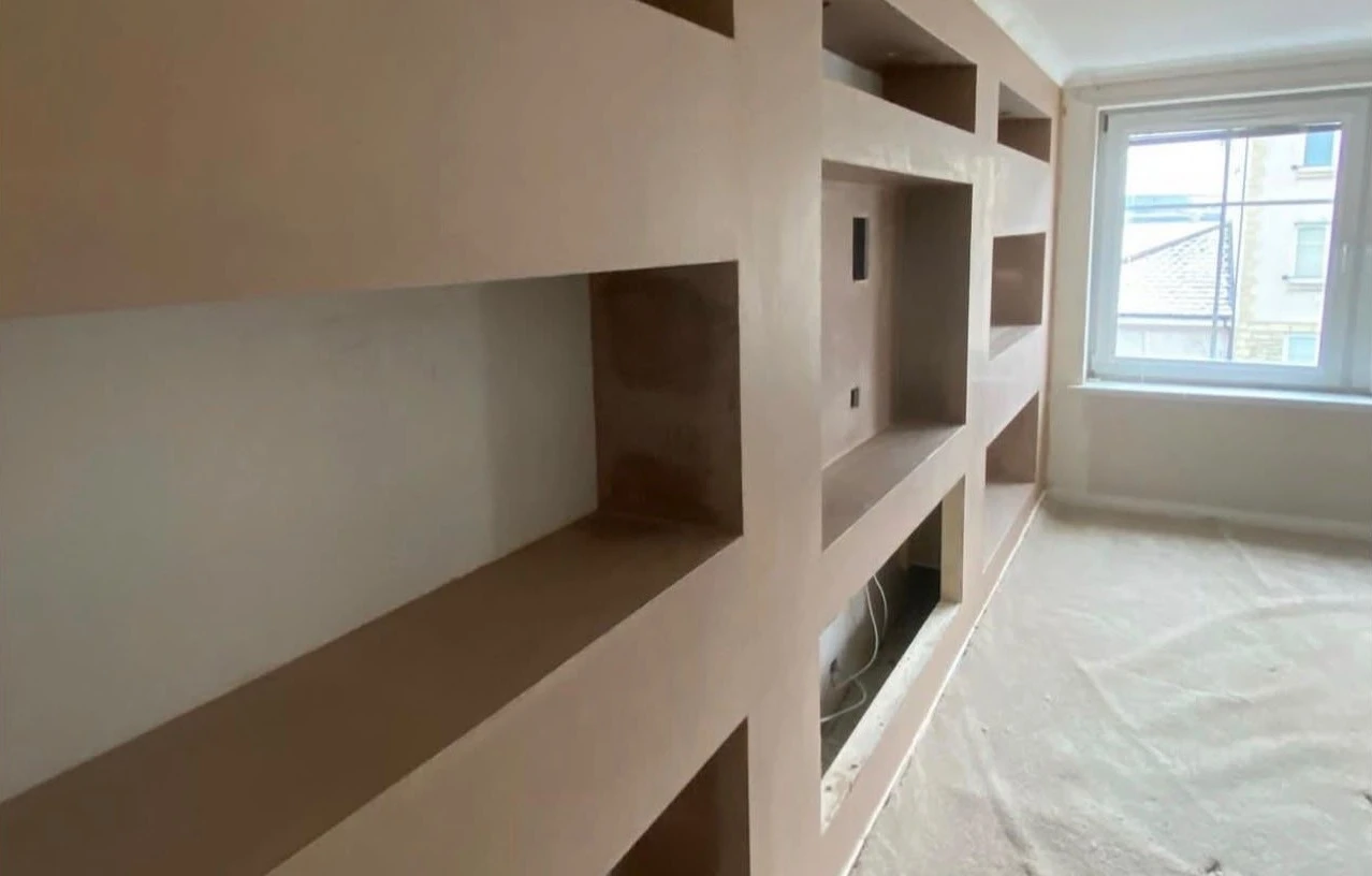 New plasterboard dry-lined media wall with built-in alcove shelving