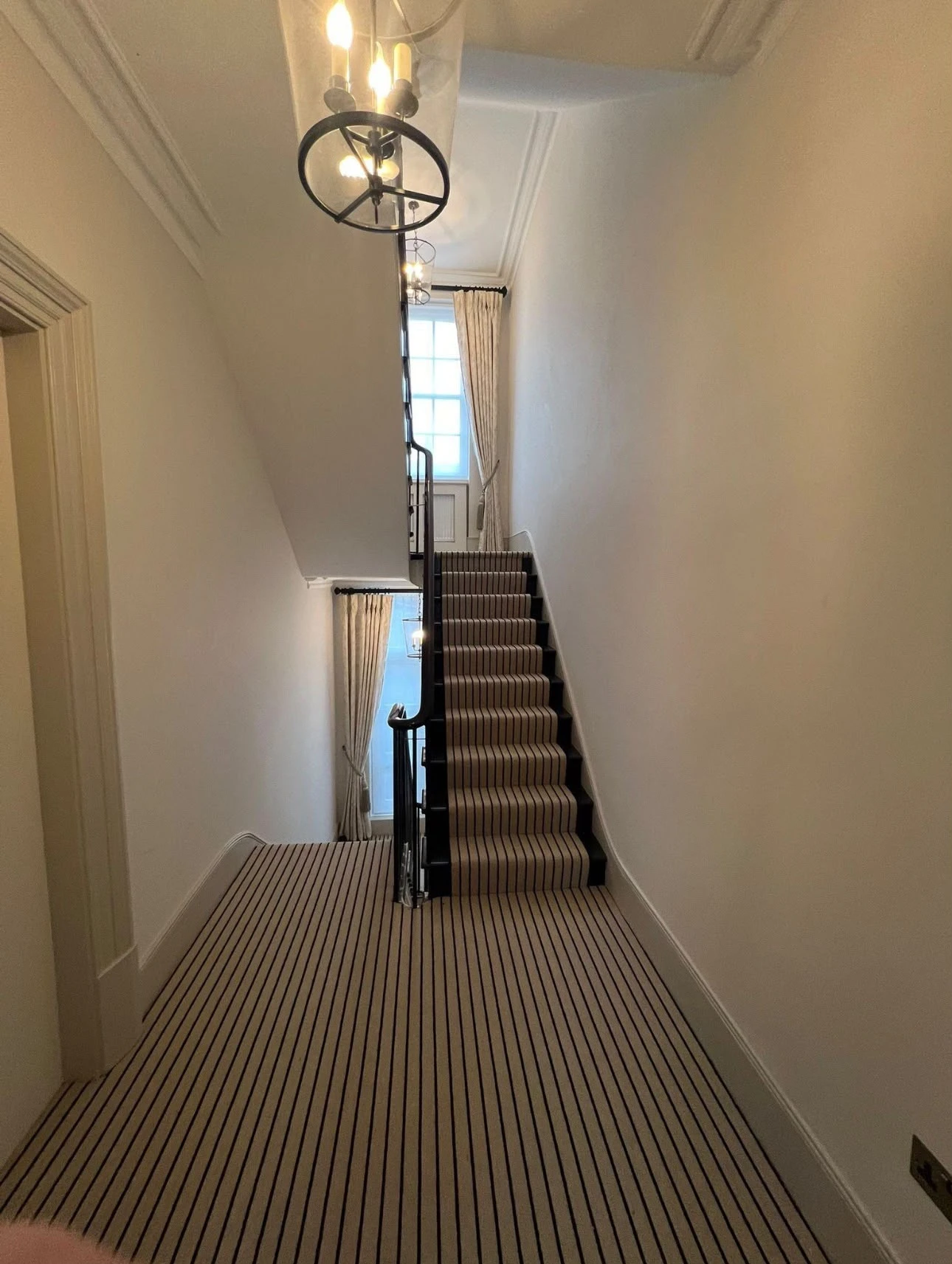 Hallway and staircase painted in soft white with crisp skirting and cornice