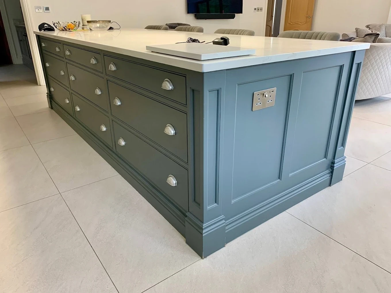 Kitchen island painted in blue-grey with shaker drawers