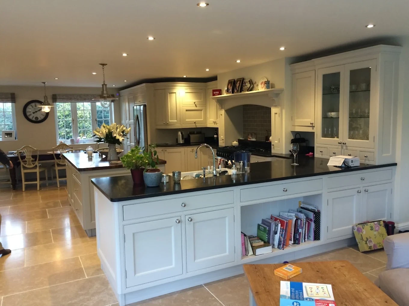 Painted cream kitchen island with black worktop in a large family kitchen