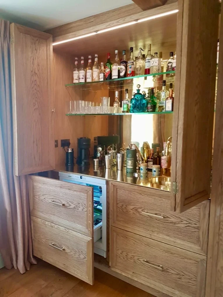 Oak bar cabinet with treated timber doors and lit glass shelving